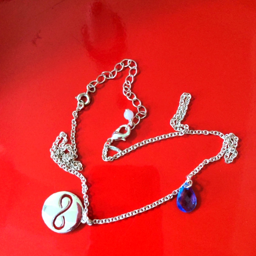 Silvertone necklace with women empowerment charm,blue stone